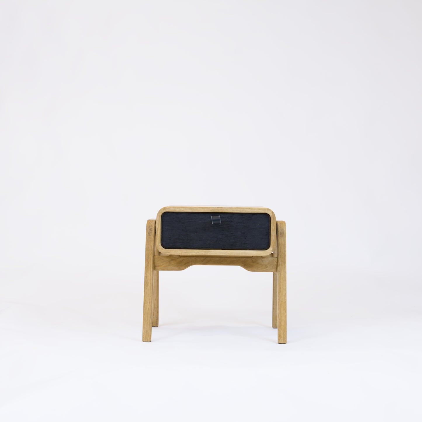 Low nightstand nm11L. The main corpus is crafted from solid Norwegian oak, featuring 1 drawer with black oak front.